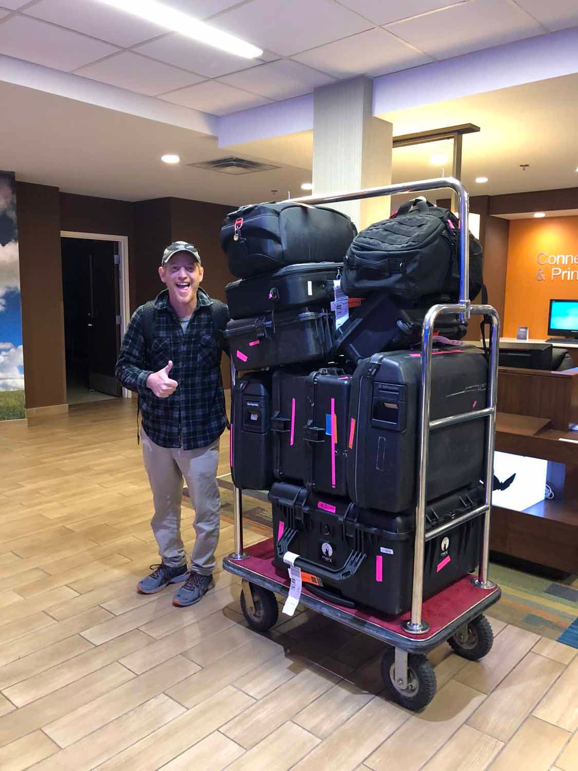 Crew member loading equipment cases for travel